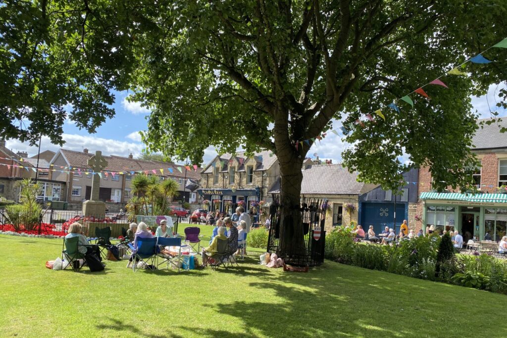 CAMEO members picnicking on the green, Washington Village